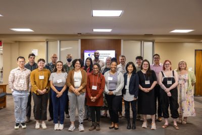 A group of smiling early-career librarians stand together for a picture.