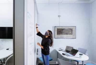 A woman drawing on a whiteboard