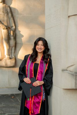 Ashley Donahoe poses in grad cap and gown at the Pylons