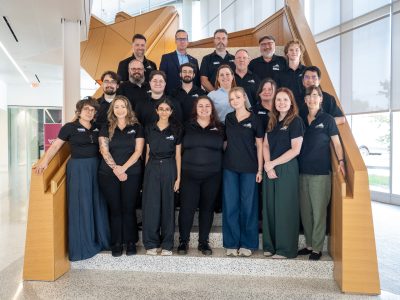 Virginia Cyber Range team members gather on the stairs for a photo during the 2026 Virginia Cybersecurity Education Conference in Alexandria. 