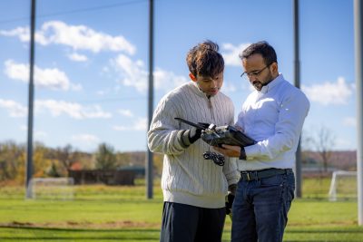 grad students test wireless signals at drone park. 